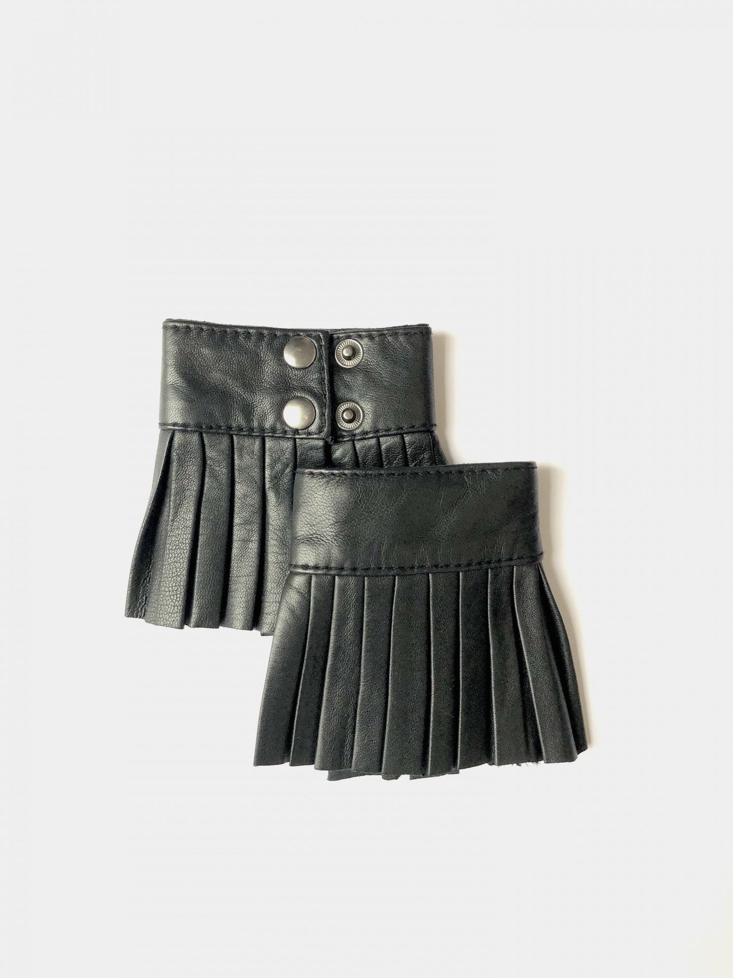Denduon black pleated leather cuffs in white background