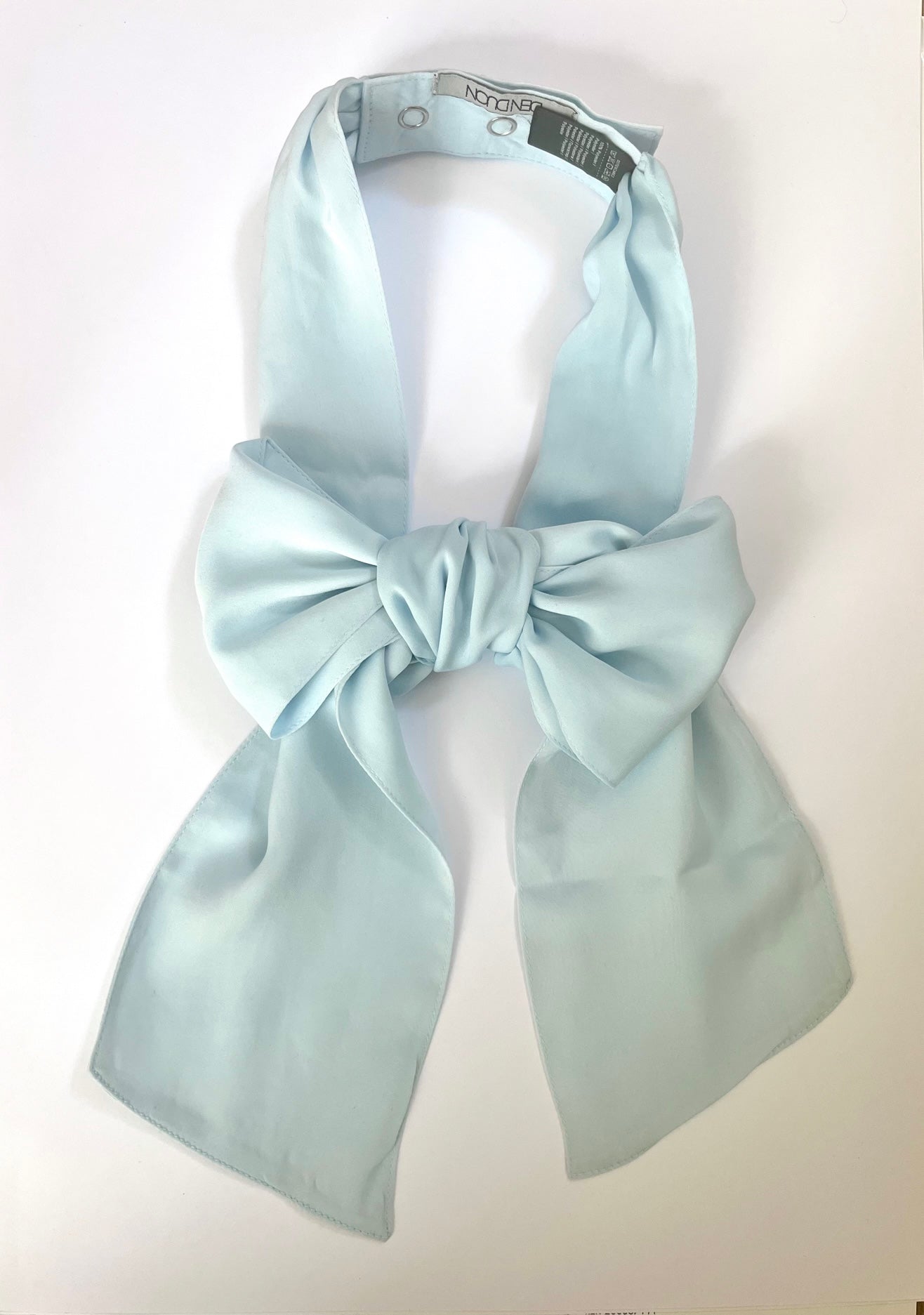 Denduon light blue signature bow in soft silky polyster on a white background