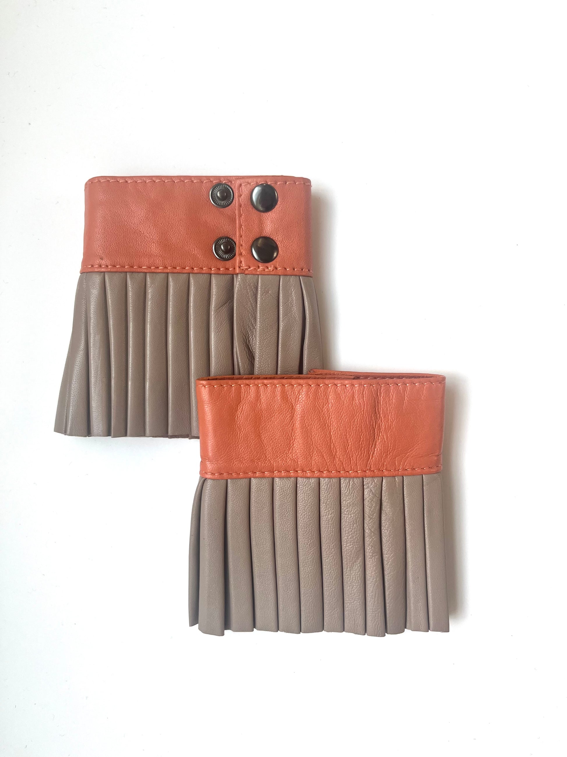 Denduon leather cuffs in blooming dahlia and mushroom colour on a white background.