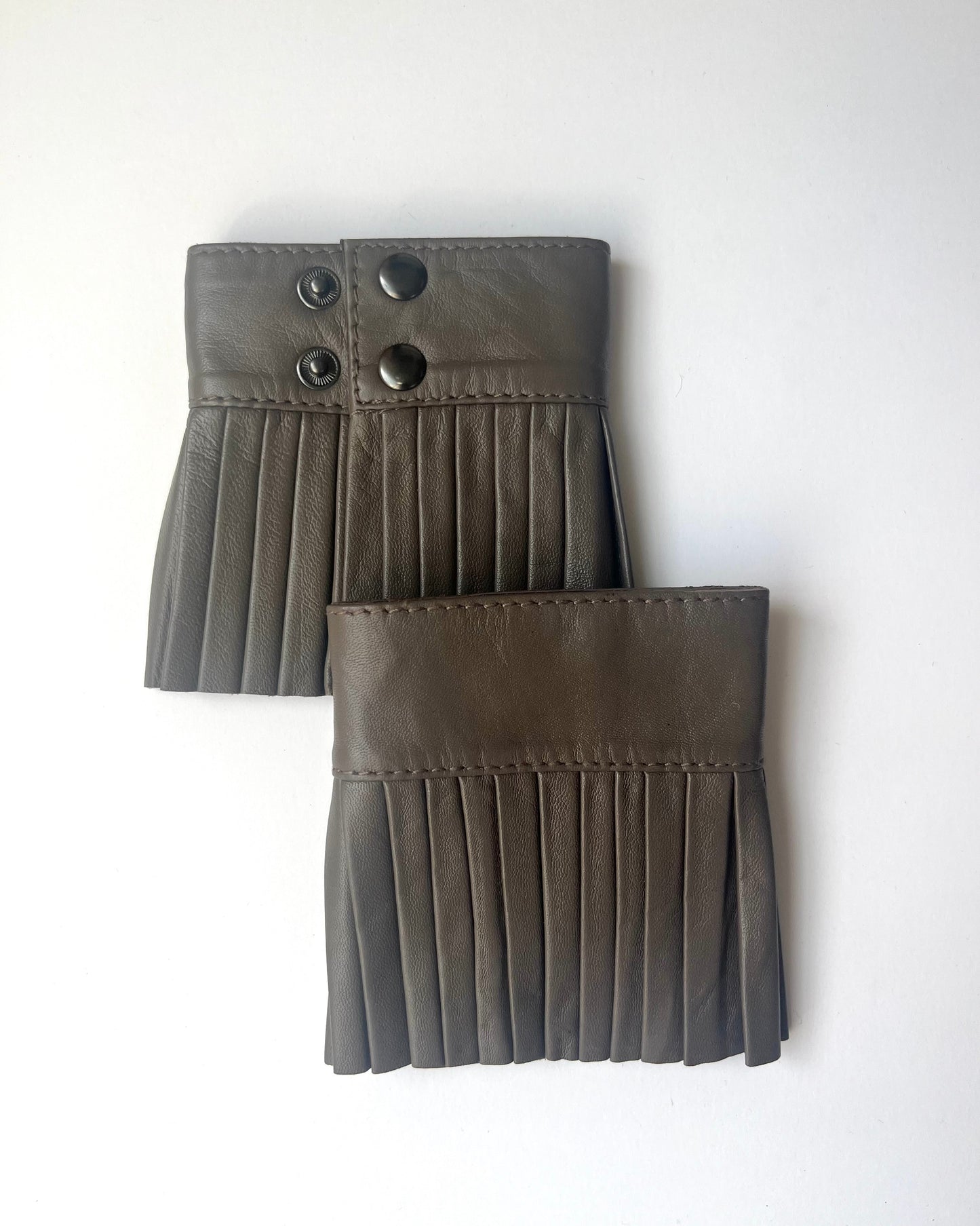 Denduon pleated leather cuffs in greige on white background