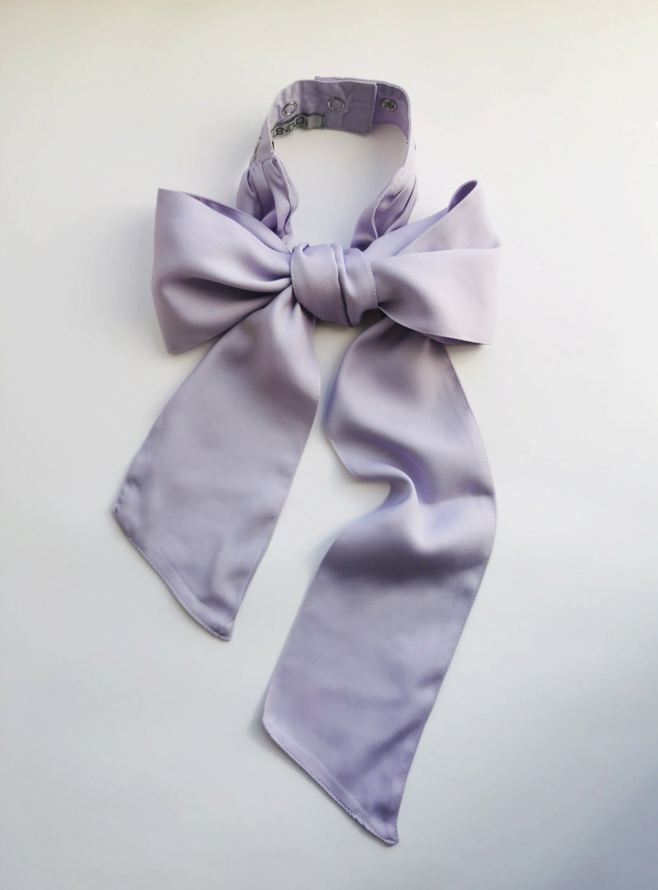 Denduon silky touch bow in lilac color on a white background.