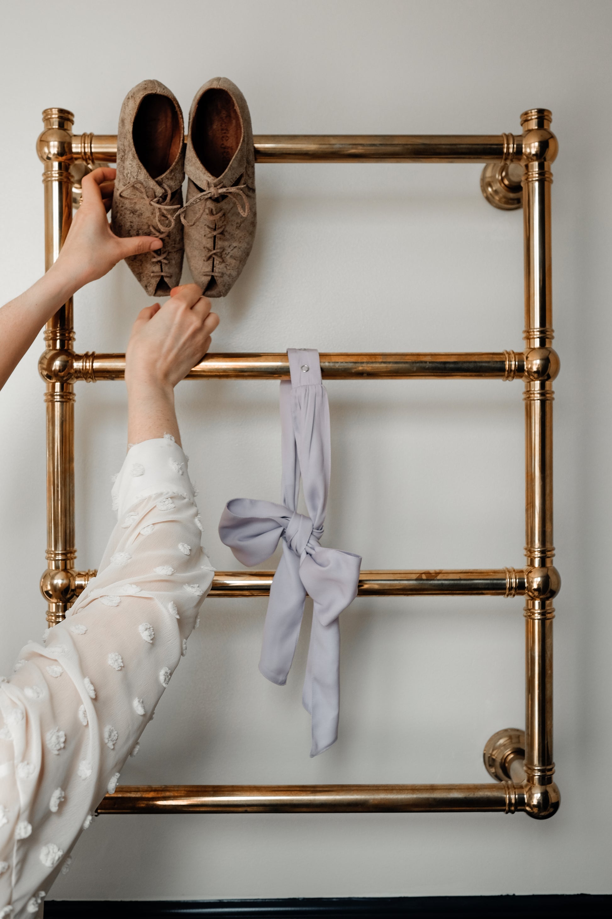Denduon textile bow in lilac hanging on  retro towel heater in hotel